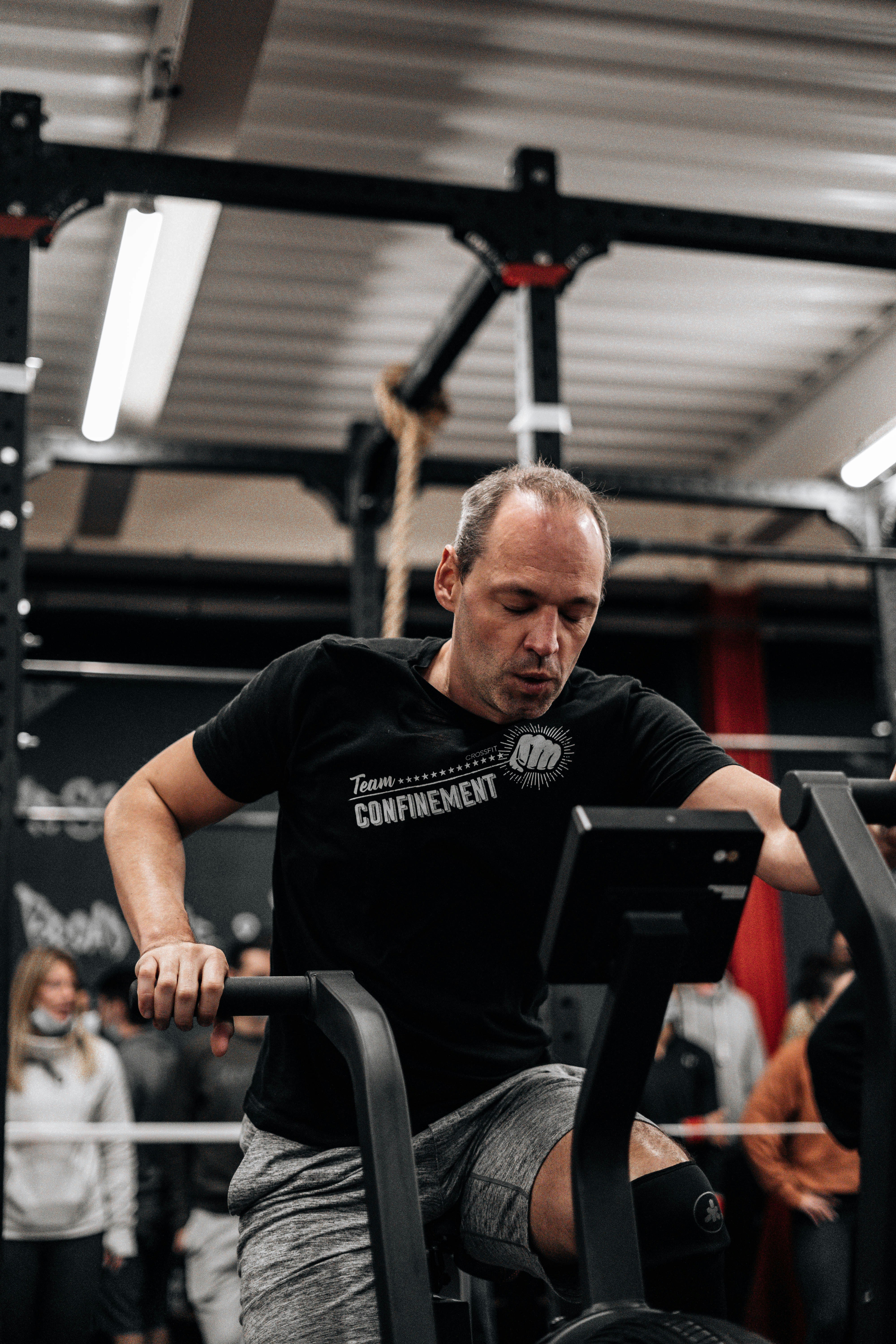 a man sitting on a bench in a gym